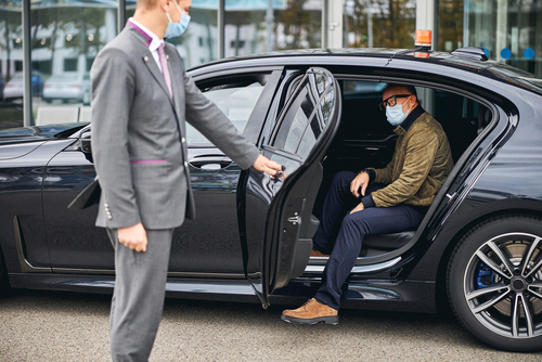 Chauffeur,Opening,The,Car,Door,For,A,Caucasian,Male,Passenger